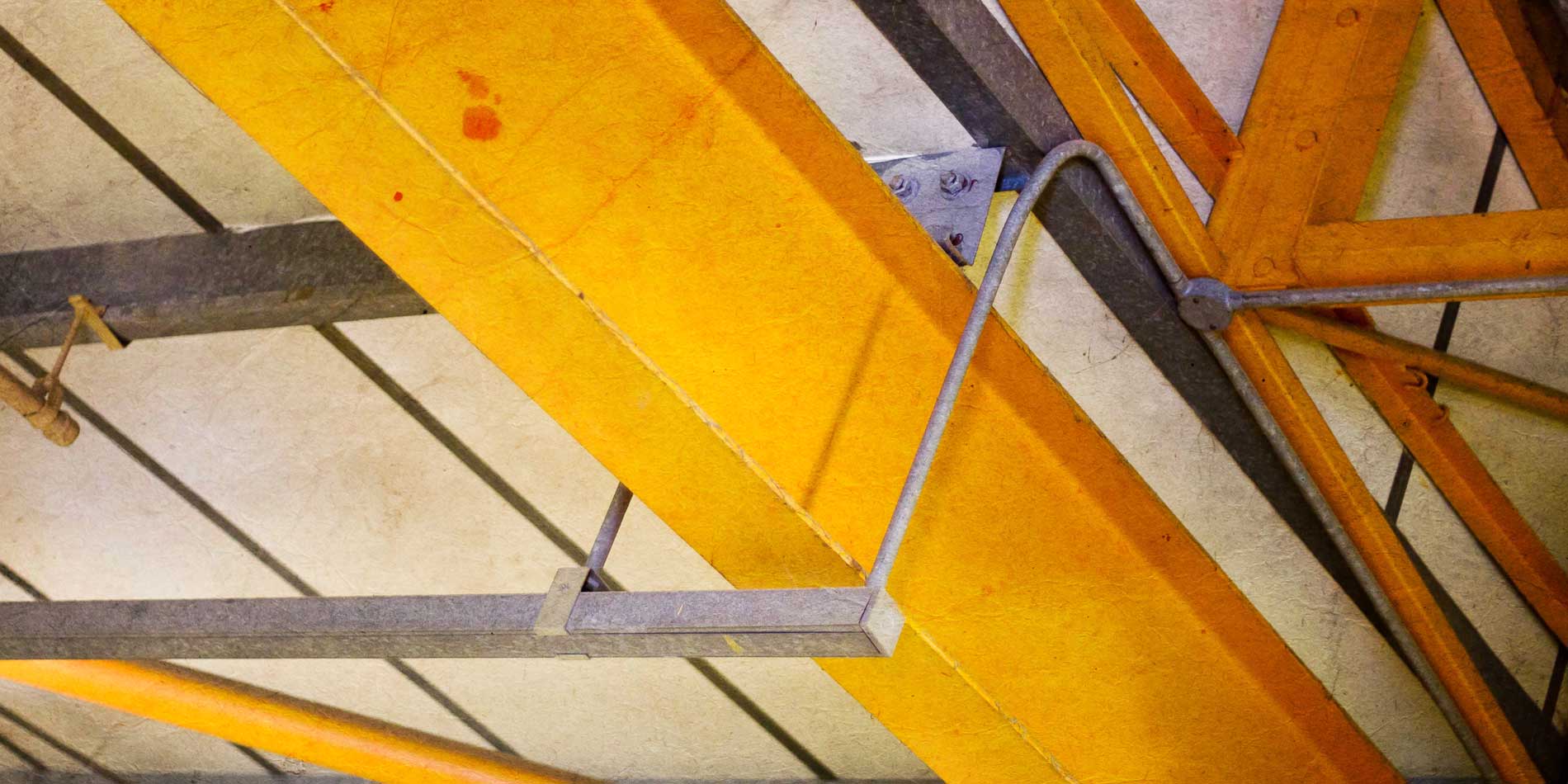 Creative image of ceiling in workshop, orange metal beams and pipes