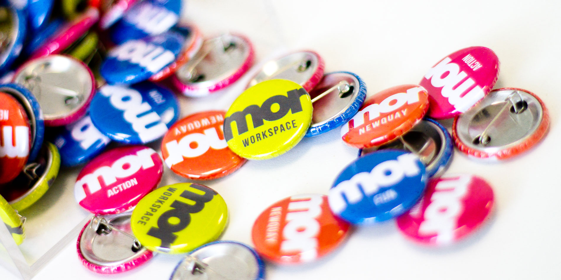 Mor Workspace branded pin badges in different colours