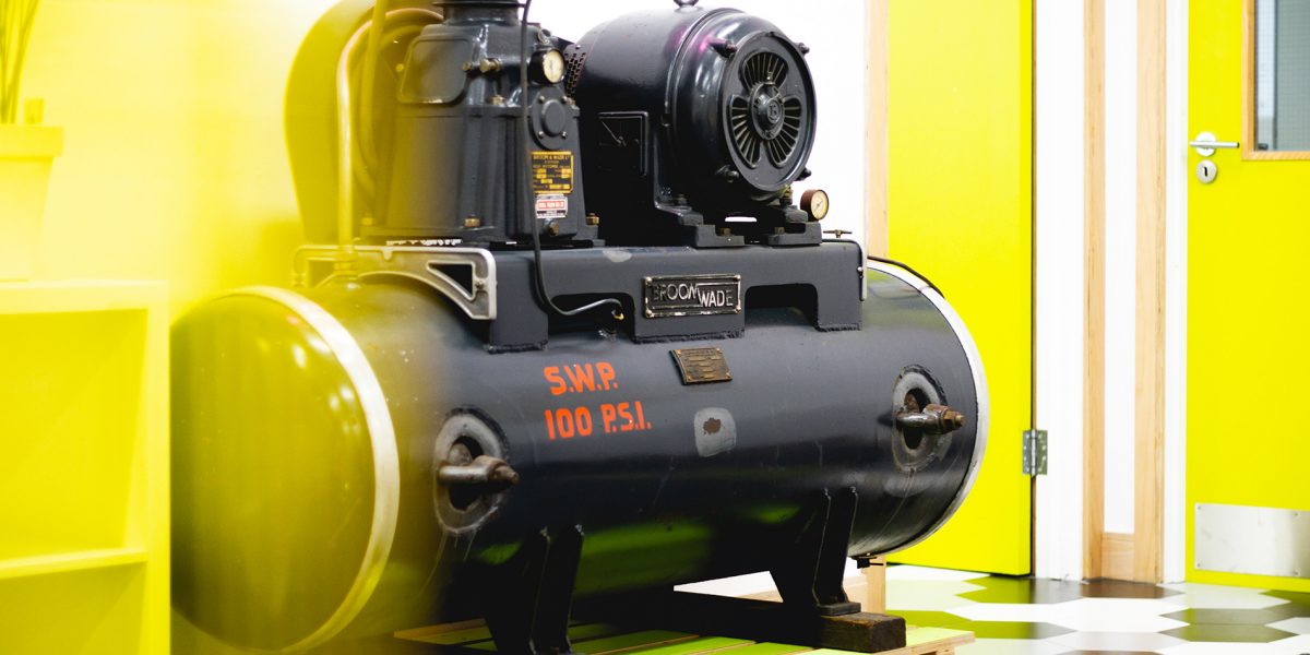 Old compressor in open workspace